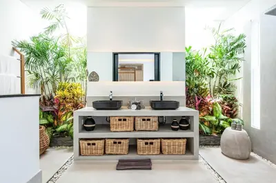a bathroom with two sinks and a mirror at Modern 4 BR Villa 400m to the Beach in Canggu in Canggu