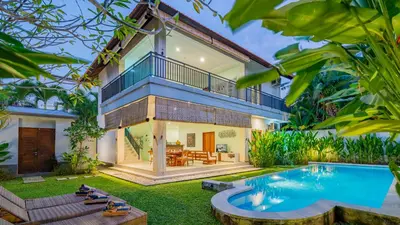 an exterior view of a house with a swimming pool at Villa Harmony - Seminyak in Seminyak