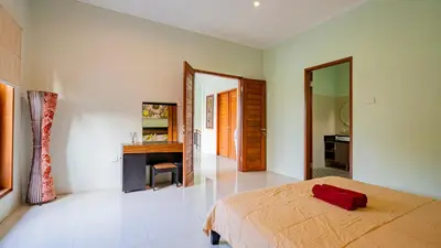 a bedroom with a bed and a desk and a mirror at Villa Harmony - Seminyak in Seminyak