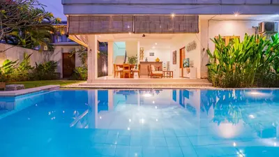 a swimming pool in front of a villa at Villa Harmony - Seminyak in Seminyak