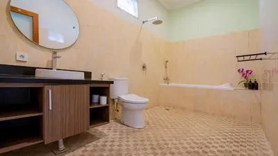 a bathroom with a toilet and a sink and a mirror at Villa Harmony - Seminyak in Seminyak