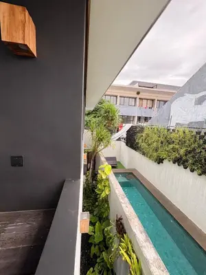 a view from the balcony of a house with a swimming pool at Town House CAMY in Seminyak