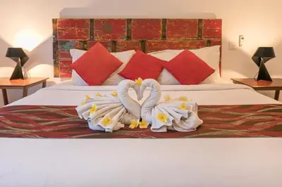 two swans made out of towels on a bed at Villa Briana Seminyak by Villas R Us in Seminyak