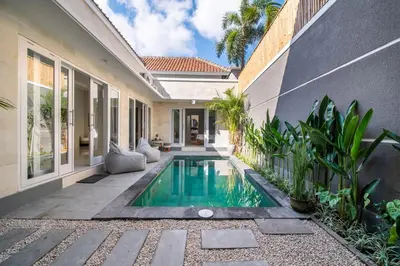 a swimming pool in the backyard of a house at Villa Della One in Seminyak