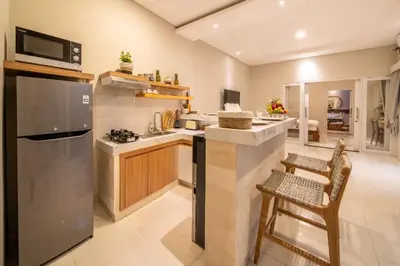 a kitchen with a stainless steel refrigerator and a counter at Villa Della One in Seminyak