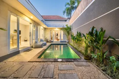 an indoor swimming pool in the backyard of a house at Villa Della One in Seminyak