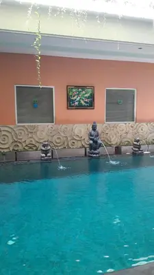 a pool of water with two water fountains at The Agung Residence in Seminyak