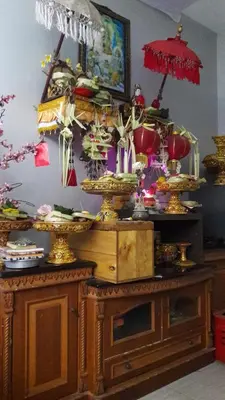 a room with a table with vases on it at The Agung Residence in Seminyak