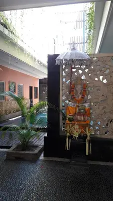 a statue of a lion sitting on a bench at The Agung Residence in Seminyak