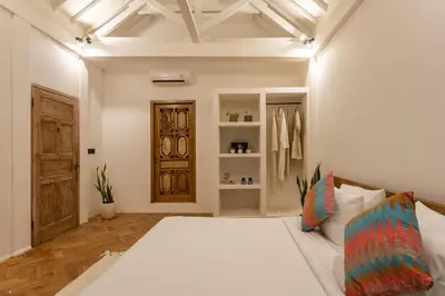 a bedroom with a large white bed in a room at 2 BDR villa, walking distance to Seminyak beach. in Seminyak