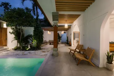 a house with a swimming pool and a patio at Villa Batu Putih Seminyak in Seminyak