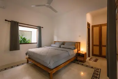 a bedroom with a bed and a window at Villa Batu Putih Seminyak in Seminyak