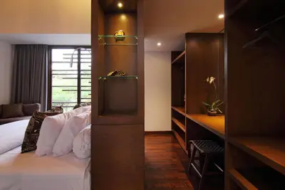 a hotel room with a bed and a window at Abivilla in Seminyak