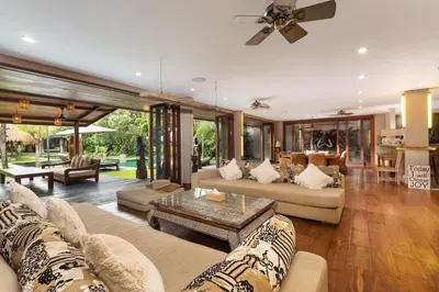 a living room with two couches and a table at Villa Yoga by Villa Finder in Seminyak