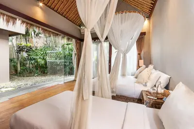 a bedroom with a bed and a window at Villa Yoga by Villa Finder in Seminyak