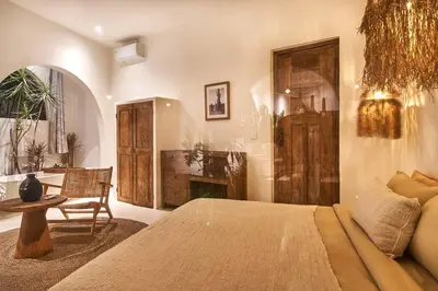a bedroom with a bed and a table and a chair at Gorgeous Mediterranean Style 2 Bed, Top Pick! in Canggu
