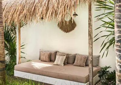 a couch in a room with palm trees at Gorgeous Mediterranean Style 2 Bed, Top Pick! in Canggu