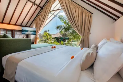 a bedroom with a large bed and a window at Villa Tramonto By Le Cielo in Canggu