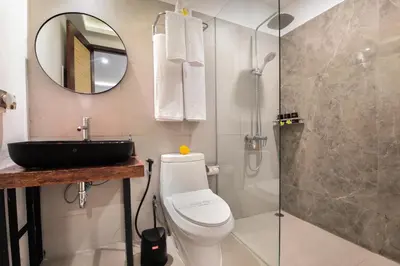 a bathroom with a sink and a toilet and a shower at Villa Tramonto By Le Cielo in Canggu