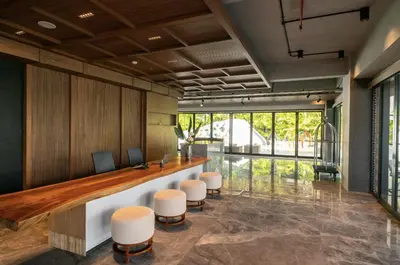 an office with a reception desk and stools at Cozy Minimalist Apartment Lavaya N511 in Nusa Dua