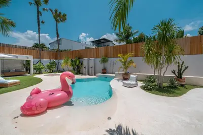 a pink flamingo swimming pool in a backyard at Berawa Breeze - Chic 4BR Beachside Oasis with Sauna in Canggu