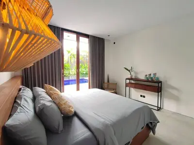 a bedroom with a large bed and a large window at Cosy Haven 2 BR Villa in Umalas in Canggu