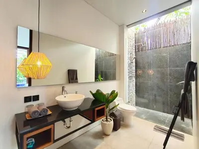 a bathroom with a sink and a toilet and a shower at Cosy Haven 2 BR Villa in Umalas in Canggu