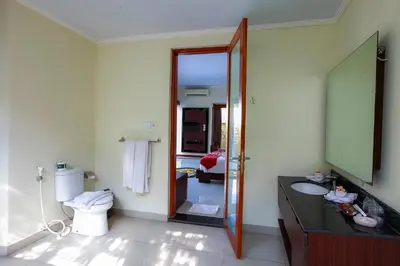 a bathroom with a toilet and a sink and a mirror at 1 Bed Room Villa In Seminyak in Seminyak