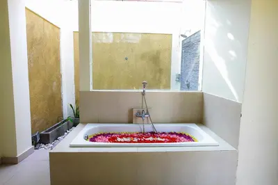 a bath tub filled with flowers in a window at 1 Bed Room Villa In Seminyak in Seminyak
