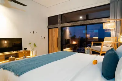 a bedroom with a large bed and a television at Alaya Homes C - Elegant Japandi Loft Suite in Seminyak in Seminyak
