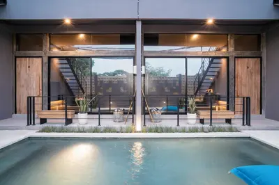 a house with a swimming pool in front of a building at Alaya Homes C - Elegant Japandi Loft Suite in Seminyak in Seminyak