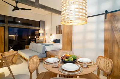 a room with a bed and a table with a bowl of fruit at Alaya Homes C - Elegant Japandi Loft Suite in Seminyak in Seminyak