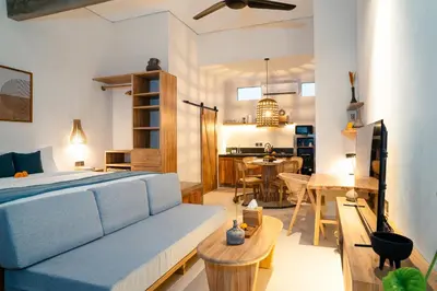 a living room with a bed and a dining room at Alaya Homes C - Elegant Japandi Loft Suite in Seminyak in Seminyak