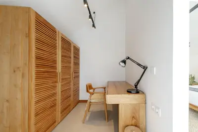 a room with a desk with a lamp and a chair at Premier Umalas Villas in Seminyak