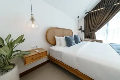 a bedroom with a bed and a potted plant at Premier Umalas Villas in Seminyak