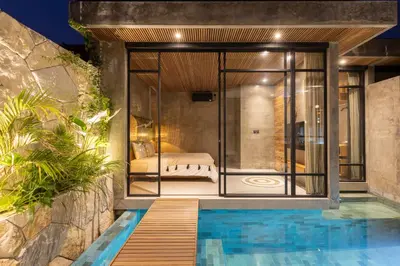 a bedroom in a villa with a swimming pool at 10 mins to beach - BRAND NEW 1 BD w/Pool + Netflix in Canggu