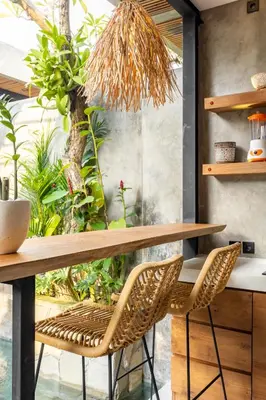 a kitchen with a table and two chairs at 10 mins to beach - BRAND NEW 1 BD w/Pool + Netflix in Canggu