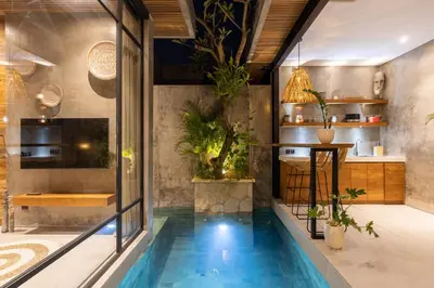 a house with a swimming pool in the middle of a room at 10 mins to beach - BRAND NEW 1 BD w/Pool + Netflix in Canggu