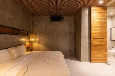 a bedroom with a large bed and a sink at 10 mins to beach - BRAND NEW 1 BD w/Pool + Netflix in Canggu
