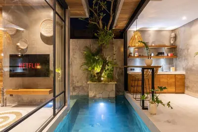 a house with a swimming pool in the middle of a room at 10 mins to beach - BRAND NEW 1 BD w/Pool + Netflix in Canggu