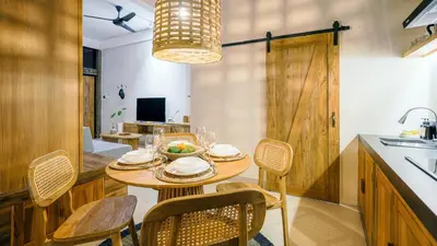 a kitchen and dining room with a table and chairs at Alaya Homes B - Stylish Japandi Loft Suite in Seminyak in Seminyak