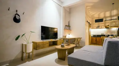 a living room with a couch and a tv at Alaya Homes B - Stylish Japandi Loft Suite in Seminyak in Seminyak