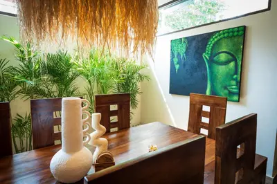 a dining room with a table and a painting on the wall at Villa WES - Legian - 5 Bedroom - 4 Bath - Location in Seminyak