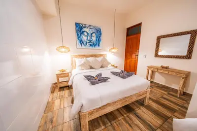 a bedroom with a bed with two bow pillows on it at Villa WES - Legian - 5 Bedroom - 4 Bath - Location in Seminyak