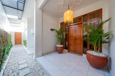 a hallway of a home with potted plants and a chandelier at Villa WES - Legian - 5 Bedroom - 4 Bath - Location in Seminyak