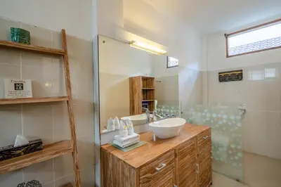 a bathroom with a sink and a mirror at Villa Alleira - 5 Bedroom Villa in Centre Location of Seminyak in Seminyak
