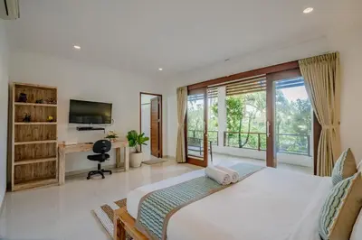 a bedroom with a large bed and a balcony at Villa Alleira - 5 Bedroom Villa in Centre Location of Seminyak in Seminyak