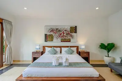 a bedroom with a large bed with two white towels at Villa Alleira - 5 Bedroom Villa in Centre Location of Seminyak in Seminyak