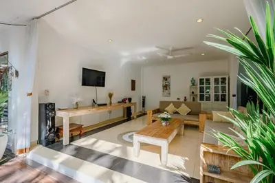 a living room with a couch and a table at Villa Alleira - 5 Bedroom Villa in Centre Location of Seminyak in Seminyak