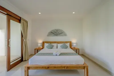 a bedroom with a bed with two towels on it at Villa Alleira - 5 Bedroom Villa in Centre Location of Seminyak in Seminyak